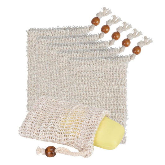 Three Diaz Beez Sisal Soap Bags, in beige and featuring a woven design, are arranged on a white background. One eco-friendly pouch holds a yellow bar of soap. Each bag, made from natural exfoliating fibers, features a drawstring closure with a wooden bead at the end.