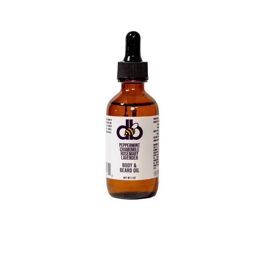 A brown bottle with a dropper cap labeled "Beard Taming Oil - Peppermint/Rosemary/Chamomile/Lavender" from the Diaz Beez brand features natural ingredients such as peppermint, rosemary, and lavender essential oils. The label showcases the brand's graphics. The bottle is set against a white background.