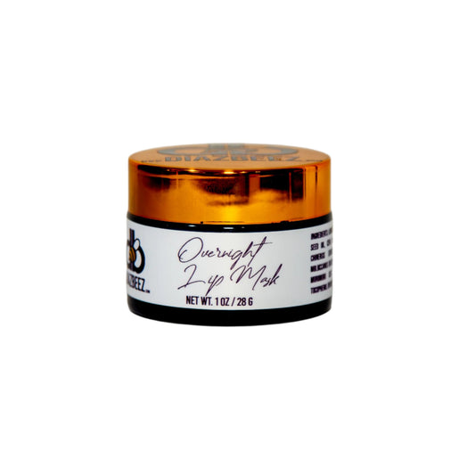 A small jar with an orange lid labeled "Overnight Lip Mask" by Diaz Beez and a net weight of 1 oz/28 g. The package, primarily white with black text and branding, is set against a plain light-colored background. This intensive lip care mask is perfect for soothing dry or chapped lips overnight.